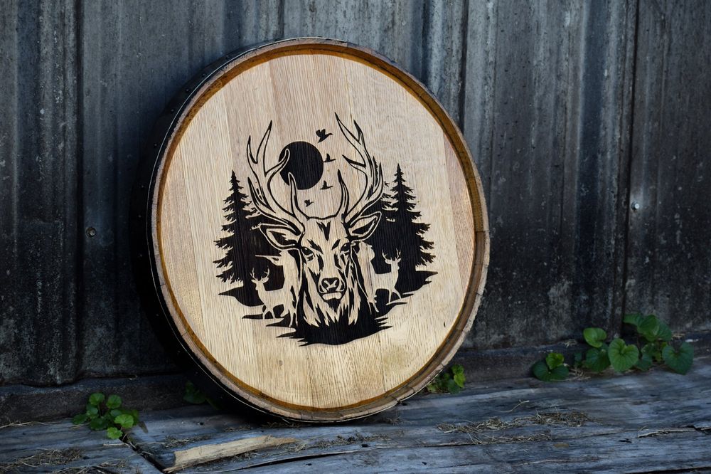 Banded barrel head engraved with a stag and pine trees