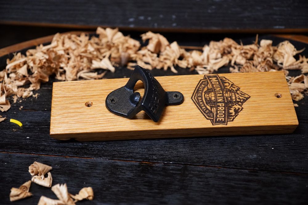 Wall-mount bottle opener on a barrel stave board