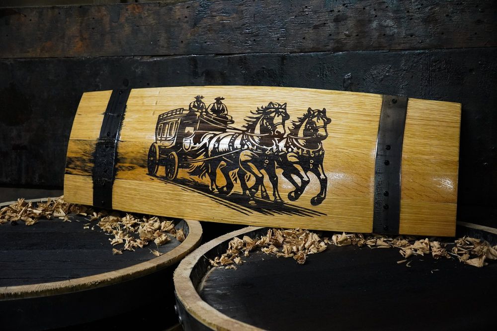 Barrel stave wall art engraved with a stagecoach and horses