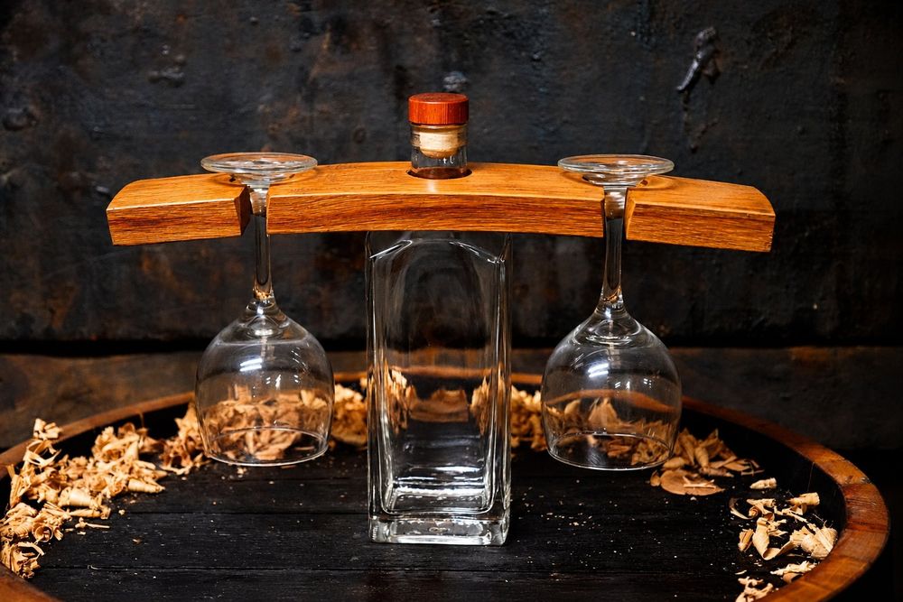 Wine display glass holder with a bottle and two hanging glasses
